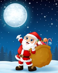 Santa Claus carrying sack full of gifts in the winter night background