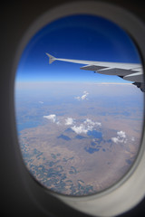 Looking through window, airplane wing and terrain with a nice bl
