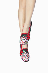 Wearing red shoes in the feet