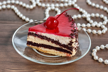 Delicious chocolate-cherry cake on plate on table