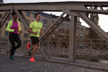 Fototapeta premium young multiethnic couple jogging in the city