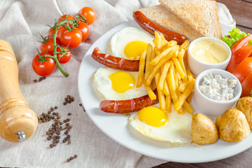 Fried eggs and fried sausage for breakfast