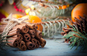 Christmas, New Year Composition with Fir Tree, Pine cones and Cinnamon. Shiny Holiday Decoration on Wooden Background