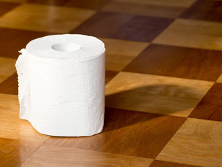 Toilet paper on the wooden floor