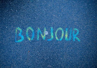 Bonjour written by colorful paints on street concrete floor © kaipong