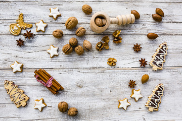 Nuts and a nutcracker on a wooden background. Winter spices and Christmas cookies. 