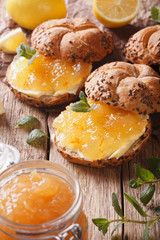 Sweet buns with lemon marmalade and butter macro. vertical