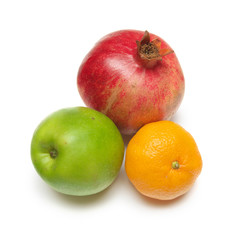 Pomegranade, apple, tangerine on white