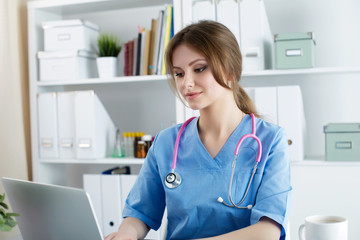 Female doctor working at her office