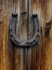 horseshoe hanging on wood door 
