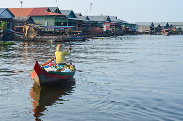 Fototapeta premium Asia woman selling product while boating on the canel or river in Tonle Sap Cambodia