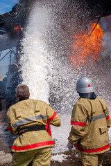 Firefighters extinguish a building