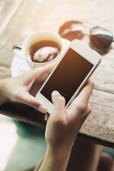 girl using smart phone in cafe. hand holding smart phone white s