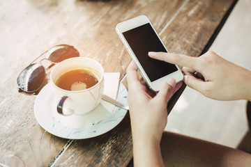 Closeup image on a female hands holding smartphone
