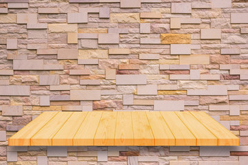 Fototapeta premium Wooden shelf on brick wall background.
