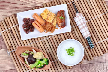 Rice gruel with sausage,clams,radish ,omelet and fried vegetable