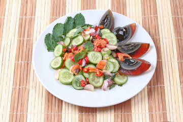 Spicy cucumber salad with dried shrimp and  preserved egg.