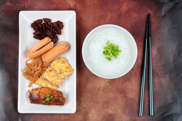 Rice gruel served with sausage ,clams,radish ,omelet and mackere