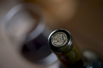 Close-up of closed wine bottles lying on blurry background