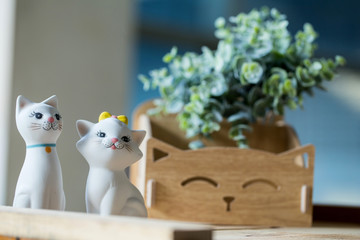 Statue of two cats made of ceramic background.