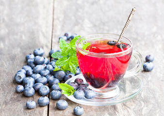 blueberry  tea with mint leaves on white background