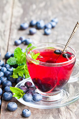 blueberry  tea with mint leaves on white background