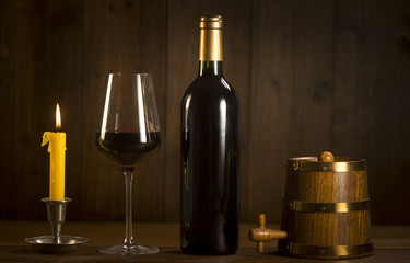 Pouring red wine into wineglass from green bottle
