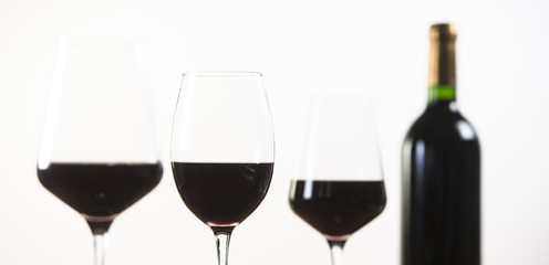 Red Wine bottle and three glass on white background
