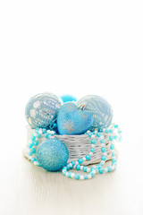 Blue Chritmas balls decorated in basket with white copy space