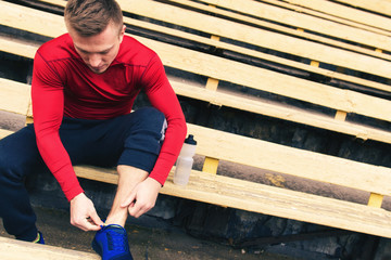 Young athlete preparing for training at the stadium