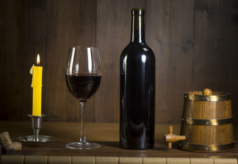 Pouring red wine into wineglass from green bottle