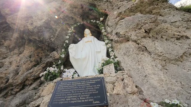Maria statue on rock wall