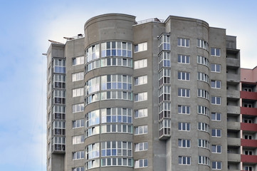 Fototapeta premium The unfinished high-rise apartment building, insulation and double glazing.