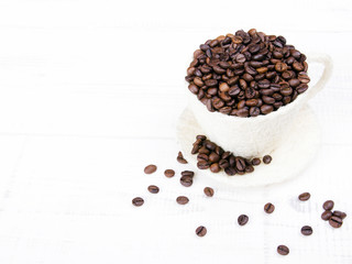  coffee beans cup on white wooden background