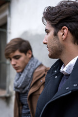 Portrait of two young man posing with fashionable winter clothes