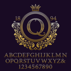 Wavy patterned gold letters and numbers with initial monogram in coat of arms form. Decorative patterned font for logo design. Isolated english vintage alphabet, figures.