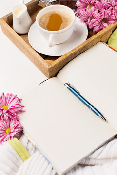 Cup of coffee, Bouquet of pink flowers, Chocolate and Empty paper sheet on white background, Beautiful card, Selective focus, copy space for text