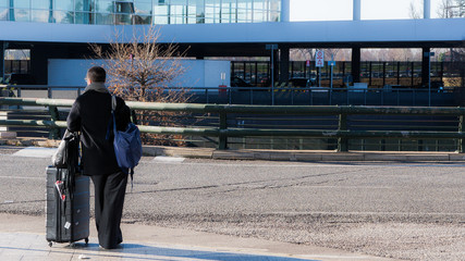 Passengers carrying luggage inside an aiport