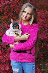 Pretty blonde girl with chihuahua on the nature