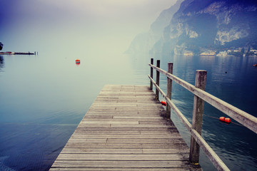 Wooden bridge on Lake Garda in Italy. Beautiful atmospheric land