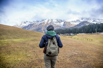 Young woman traveler with a backpack on the background of the Al