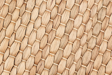 Fototapeta premium Bamboo woven beige mat handmade background. Wicker wood texture. Diagonal strips.
