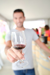 Man holding a glass of red wine