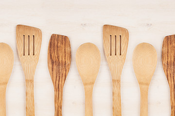 Design concept of mock up of empty wood beige spoons on white wood background.  Copy space. Top view.