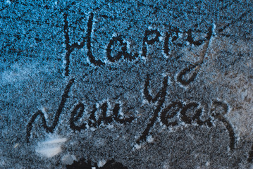 write Happy New Year on the snow, the snow on iron background, inscription,