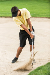 Golfer. Golfer playing from sand bunker