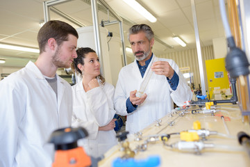 teacher showing students the functioning of a system