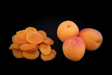 Apricots and dried apricots. Photo with black background