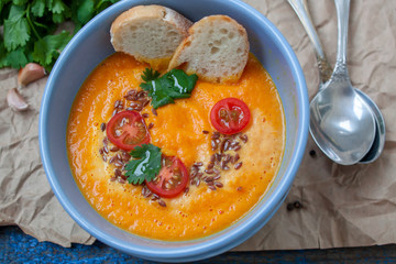 Vegan orange vegetable soup (carrots, sweet potatoes, pumpkin) with herbs and coconut cream.  Perfect for the detox diet or just a healthy meal.  Love for a healthy raw food concept.