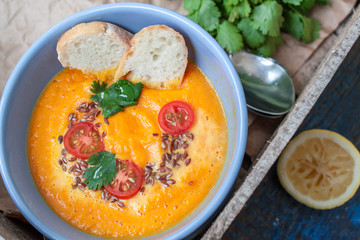 Vegan orange vegetable soup (carrots, sweet potatoes, pumpkin) with herbs and coconut cream.  Perfect for the detox diet or just a healthy meal.  Love for a healthy raw food concept.